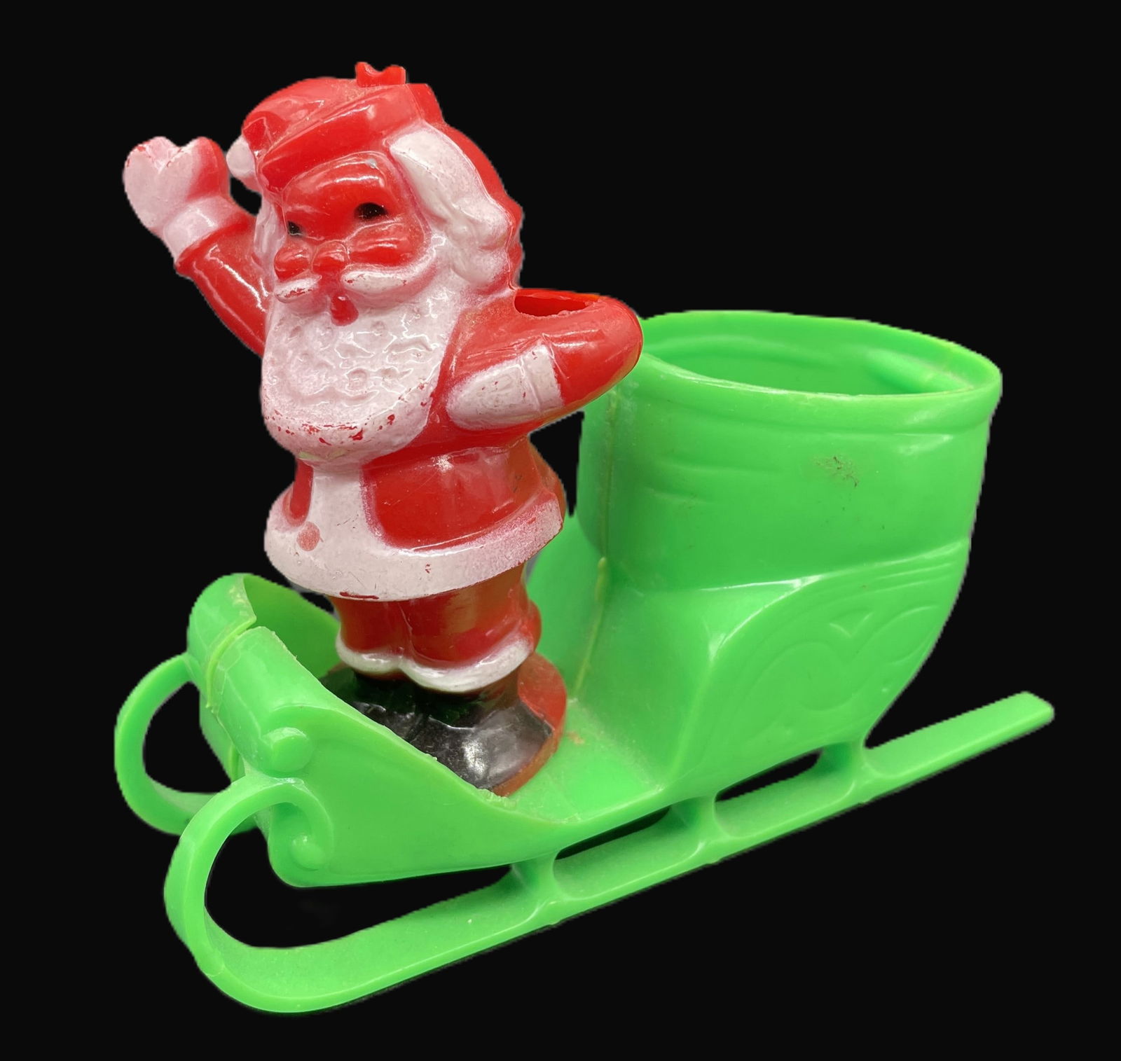 Vintage Rosbro Rosen Santa in Green Sleigh Candy Container Lollipop Holder: Date/Period: approx 1950's Dimension: approx 4" tall x 4.5" long Material: plastic Additional Information: The Vintage Rosbro Rosen Santa in Green Sleigh Candy Container Lollipop Holder is a charming