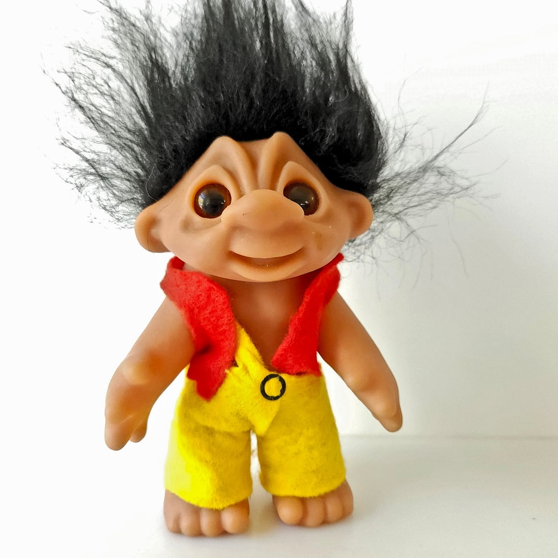 1977 Thomas Dam Troll Doll 7” Denmark: Title: 1977 Thomas Dam Troll Doll 7” Denmark Description: Thomas Dam "Good Luck Troll" doll with black hair and amber glass eyes, wearing original red and yellow felt outfit. Very Good Condition