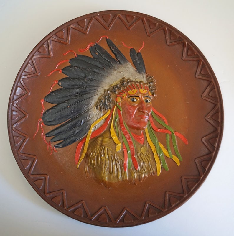 Antique Native American Indian Cast Iron Plaque: Title: Antique Native American Indian Cast Iron Plaque Dimension: 12 ¾” diameter x 1 3/8” deep. Date: Circa 1920’s. Additional Information: Outstanding figural cast iron Antique