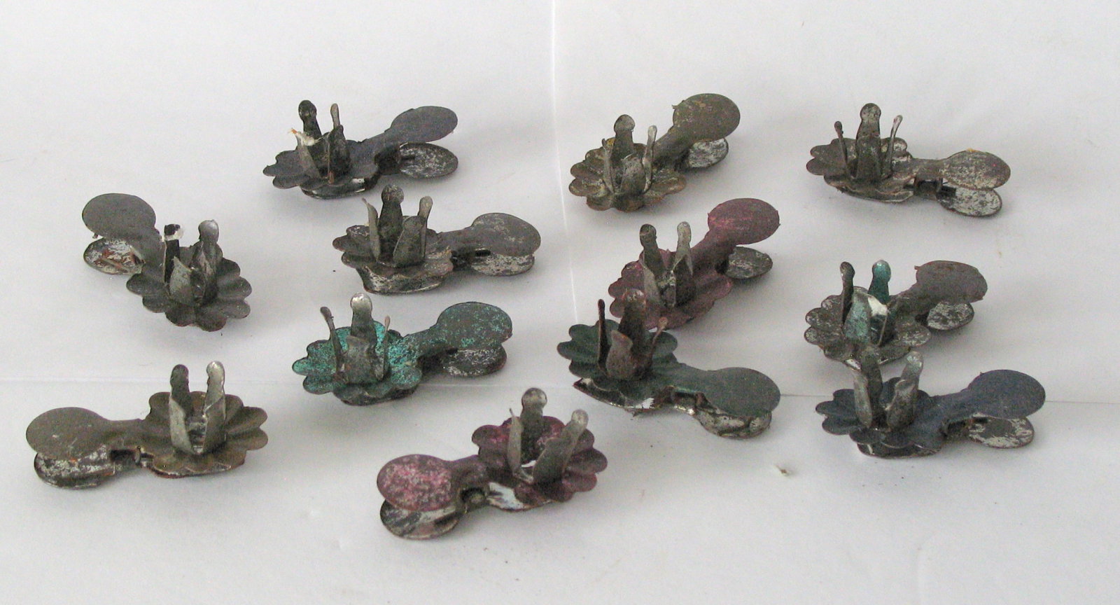 Group of 10 antique tin Christmas feather tree candle clips: Title: Group of 10 antique tin Christmas feather tree candle clips Date/Period: 1920's Dimension: 1 1/2” long each Additional Information: Nice group of 10 antique tin Christmas feather tree can