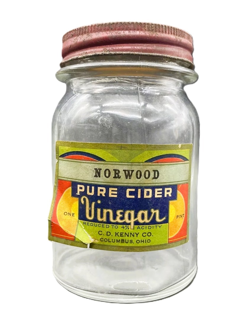 Vintage NORWOOD PURE CIDER VINEGAR GLASS JAR" C.D. Kenny Co. Baltimore Maryland: Date/Period: unknown Dimension: Approx. 5" tall x 3" diameter Material: glass Additional Information: Add a touch of vintage charm to your kitchen or collection with this clear glass jar from NORWOOD.