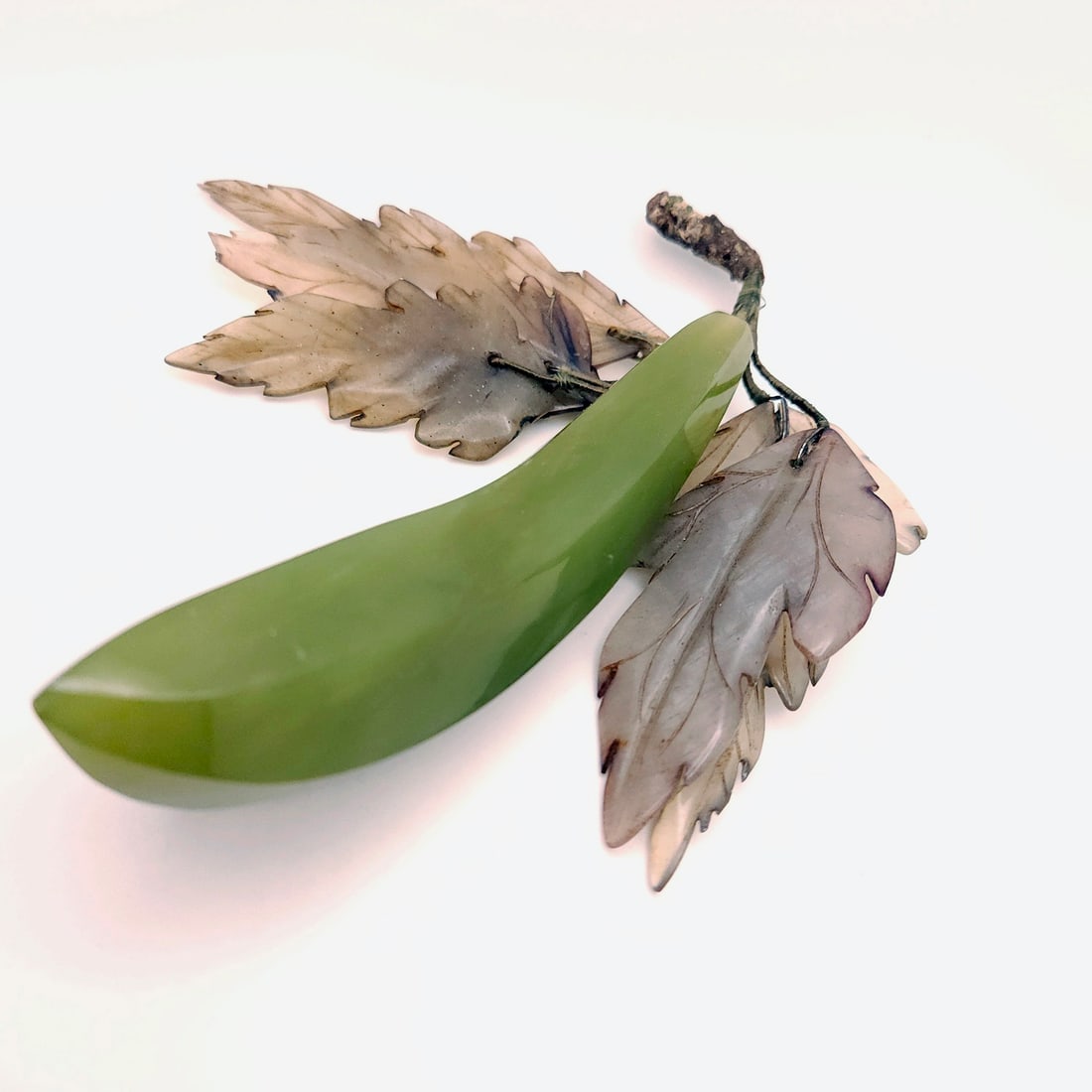 Vintage hand carved and polished jade banana or pea pod with tran: Title: Vintage hand carved and polished jade banana or pea pod with tran Description: Vintage hand carved and polished jade banana or pea pod with translucent detailed grey-green leaves. In Chinese cu