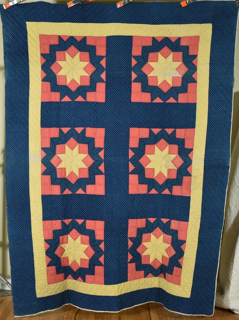 1870's Carpenter's Wheel Quilt: This VIBRANT cotton 1870's carpenter's wheel quilt is hand pieced and hand quilted, with an indigo blue background. It measures 68" X 90" and is in good condition, with subtle discoloration in some of