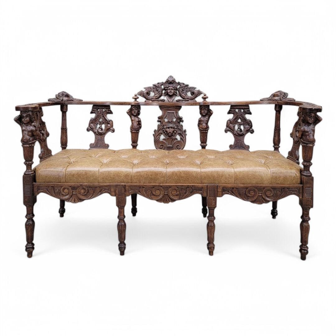 Antique Italian Renaissance Revival Ornate Figural Tufted Parlor Bench Newly Reupholstered in: Antique Italian Renaissance Revival Carved Ornate Figural Walnut Button Tufted Parlor Bench Newly Reupholstered in Full Grain Italian Distressed Whiskey Leather This exquisite bench is a stunning addi