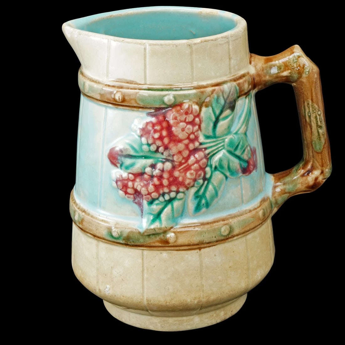 Majolica Berry Cream Pitcher 19th Century: Title:Majolica Berry Cream Pitcher 19th Century Size:5 5/8 in (14.3 cm) tall x 4 in (10.2 cm) diameter. Description:A small and colorful antique majolica pitcher with a molded design of berries that w