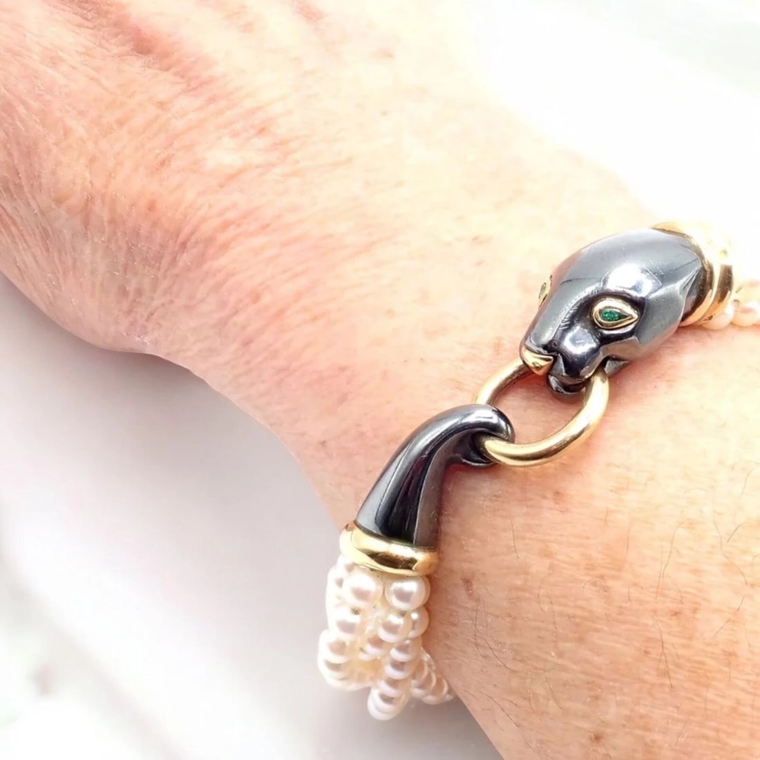 Panthere de Cartier Panther 18k Yellow Gold & Silverium Pearl Emerald Bracelet: Panthere de Cartier Panther 18k Yellow Gold & Silverium Pearl Emerald Bracelet About This Piece: The Panthere de Cartier bracelet showcases the iconic panther in 18k yellow gold and Silverium, accente