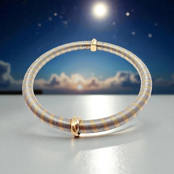 Authentic Vintage Cartier 18k Yellow Gold + Steel Bangle Trinity Bracelet: Authentic Vintage Cartier 18k Yellow Gold + Steel Bangle Trinity Bracelet About This Piece: This vintage Cartier Trinity bangle showcases timeless elegance in 18k yellow gold and stainless steel. The