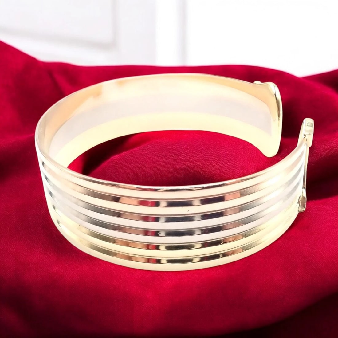 Authentic! Cartier 18k Tri-Color Gold Double C Wide Cuff Bangle Bracelet: Authentic! Cartier 18k Tri-Color Gold Double C Wide Cuff Bangle Bracelet About This Piece: The Cartier 18k Tri-Color Gold Double C Wide Cuff Bangle Bracelet is a luxurious statement piece showcasing C