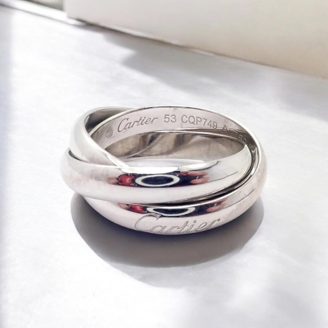 Authentic! Cartier 18k White Gold Trinity Band Ring Size 53 US 6.25: Authentic! Cartier 18k White Gold Trinity Band Ring Size 53 US 6.25 About This Piece: The Cartier 18k White Gold Trinity Band Ring is a refined piece, featuring Cartier's iconic triple-band design. Ma