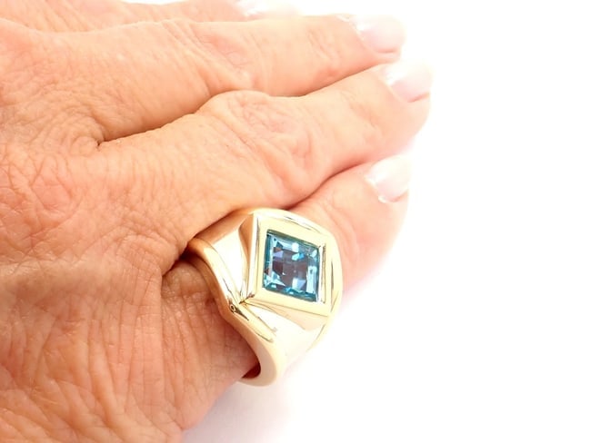 Authentic! Marina B 18k Yellow And White Gold Large Blue Topaz Ring: Authentic! Marina B 18k Yellow And White Gold Large Blue Topaz Ring About This Piece: These earrings are for pierced ears. Metal: 18k Yellow & White Gold Size: 6.25 Weight: 19.3 grams Stones: 1 large