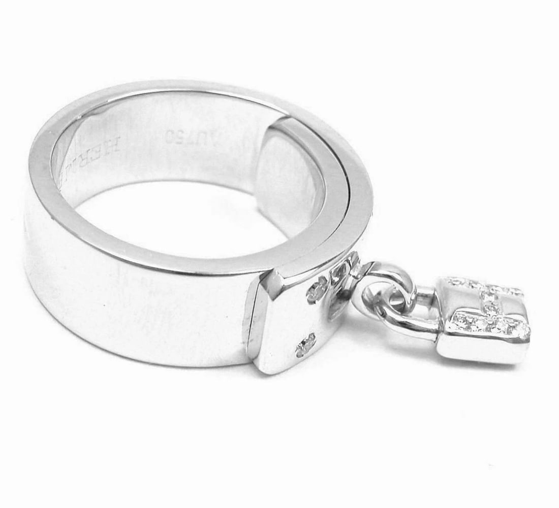 Rare! Authentic Hermes 18k White Gold "H" Lock Band Diamond Ring: Rare! Authentic Hermes 18k White Gold "H" Lock Band Diamond Ring About This Piece: Metal: 18k White Gold Weight: 15.5 grams Width: 7mm Size: 50 US 5 Hallmarks: Hermes 750 50 93071 0703mhtd <