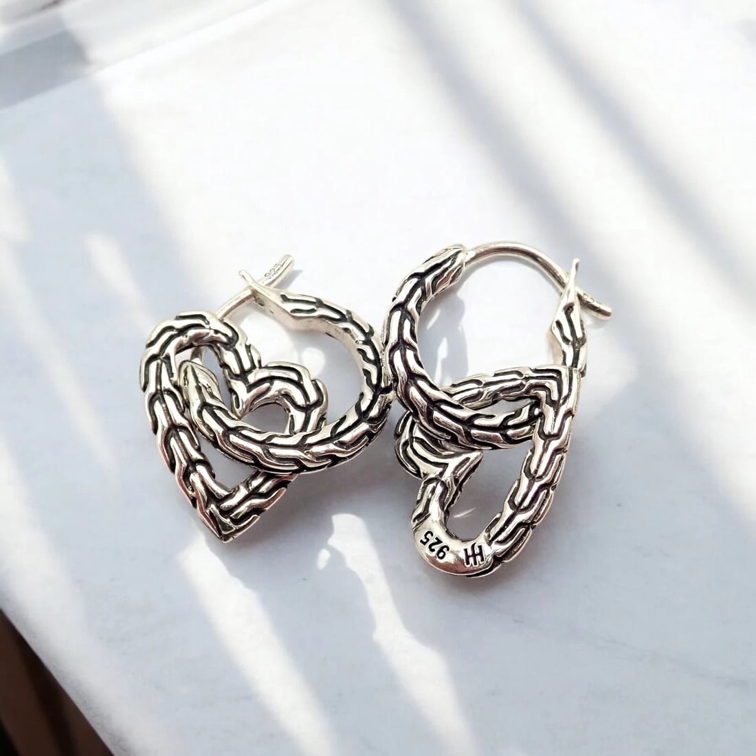 Authentic! John Hardy JH Silver Manah Heart Earrings: The Authentic John Hardy JH Silver Manah Heart Earrings feature elegant, heart-shaped sterling silver designs, embodying love and connection. With intricate craftsmanship and a polished finish, these