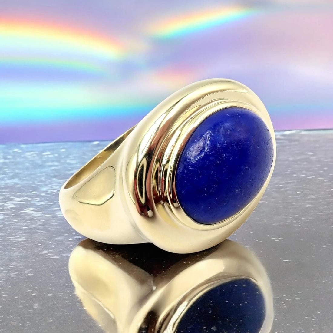 Authentic! Tiffany & Co Paloma Picasso 18k Yellow Gold Large Lapis Oval Ring: This bold Tiffany & Co. Paloma Picasso ring features a striking oval lapis lazuli cabochon set in rich 18k yellow gold. With smooth, sculptural lines and Picasso’s signature artistic flair, this