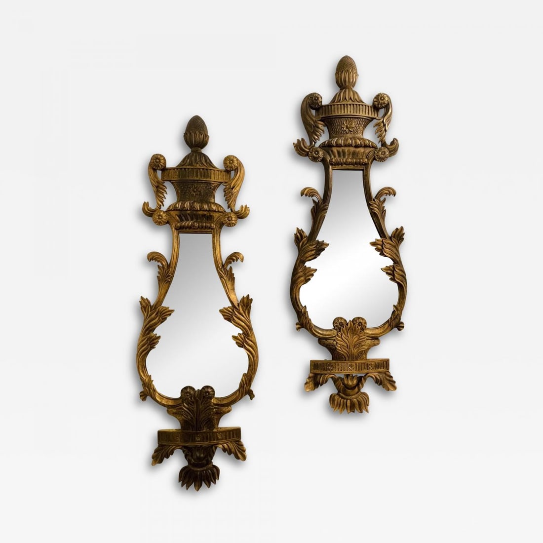 Pair of Giltwood Mirrors, Wall, Console or Pier Mirrors, Italian, 1960s: Title: Pair of Giltwood Mirrors, Wall, Console or Pier Mirrors, Italian, 1960s Description: A fine pair of Italian Giltwood Wall or Console Mirrors. The pair having a harp shape with pinapple carved p