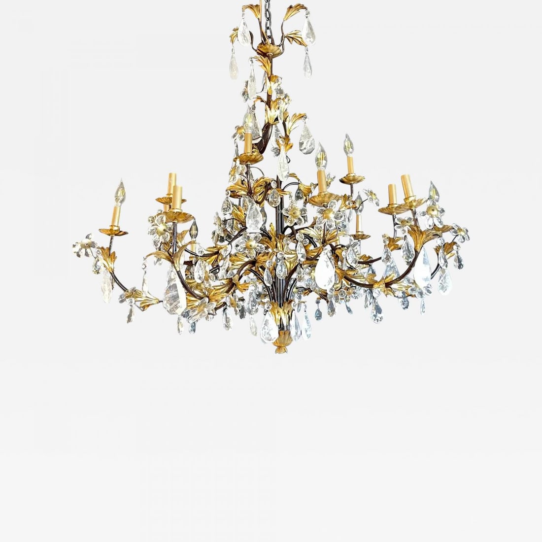 Louis XVI Style Rock Crystal Chandelier, Ebony and Gilt Metal Design: Title: Louis XVI Style Rock Crystal Chandelier, Ebony and Gilt Metal Design Description: A Hollywood Regency or Louis XVI Style chandelier having many large and impressive rock crystals prisms hanging