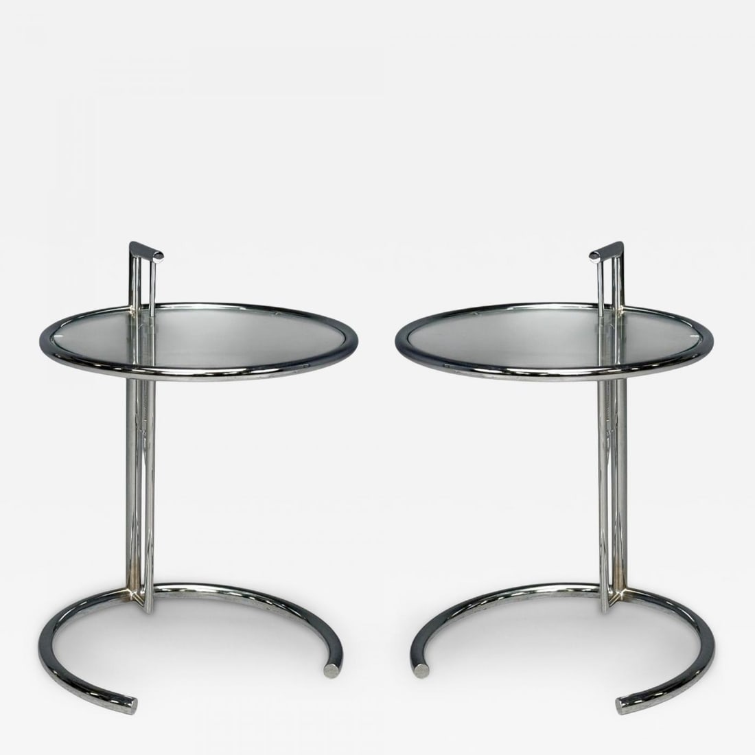 Eileen Gray, Chrome, Glass, Adjustable Side Tables, Italy, 1970s: Title: Eileen Gray, Chrome, Glass, Adjustable Side Tables, Italy, 1970s Description: Eileen Gray, Mid-Century Modern, Chrome, Glass, Adjustable E-1027 Side Tables, Italy, 1970s Pair of chrome and glas