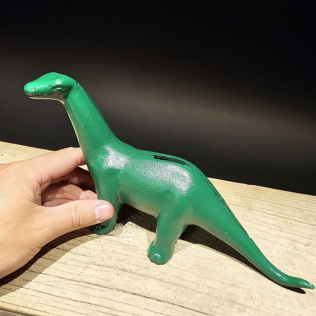 Cast Iron Brontosaurus Dinosaur Coin Bank: Great reproduction cast iron coin bank. All cast iron hand painted, slightly distressed as shown in the images. Certainly looks old! Reserve: $25.00 Shipping: Domestic: Flat-rate of $18.00 to anywhere