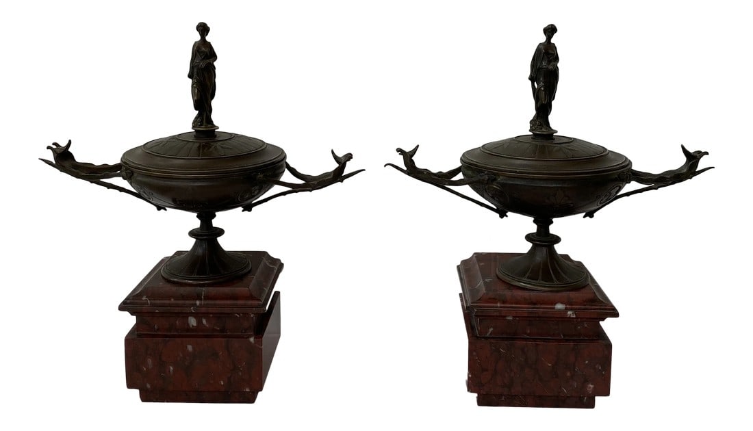 19th Century French Napoleon III Period Bronze Lidded Urns on Marble Bases - a Pair: Beautiful pair of antique French Lidded Bronze Urns on Heavy Dark Red Marble Bases. They are from the Napoleon III Period. This pair of 19th century French bronze lidded urns on marble bases is a stun