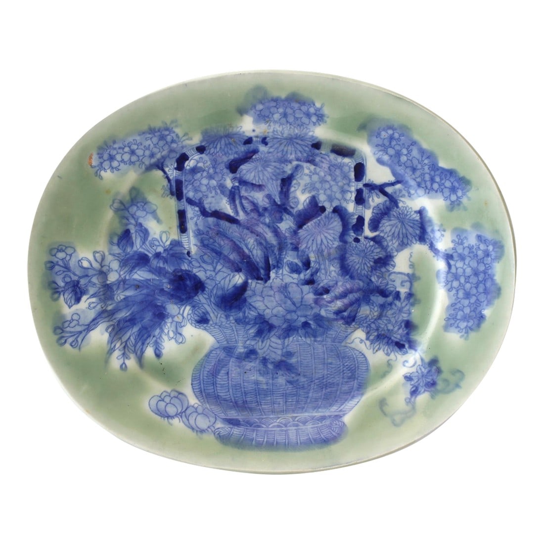 Antique Japanese Porcelain Celadon Plate: This exquisite antique Japanese celadon plate features a beautiful hand-painted floral motif, with vibrant blue flowers delicately arranged in a basket. The plate's celadon glaze creates a soft greeni