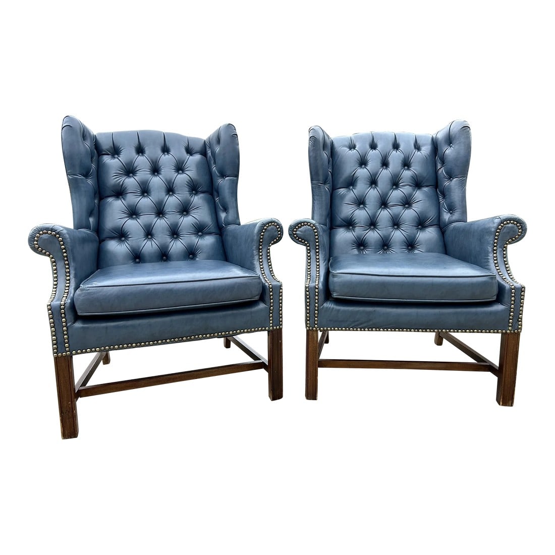 Mid-Century Chesterfield Wingback Chairs, a Pair - Tufted Blue Faux Leather With Nailhead Detailing: Elegant Mid-Century Chesterfield Wingback Chairs – Tufted Navy Faux Leather with Nailhead Detailing Enhance your living space with this exquisite pair of mid-century Chesterfield wingback chairs, de