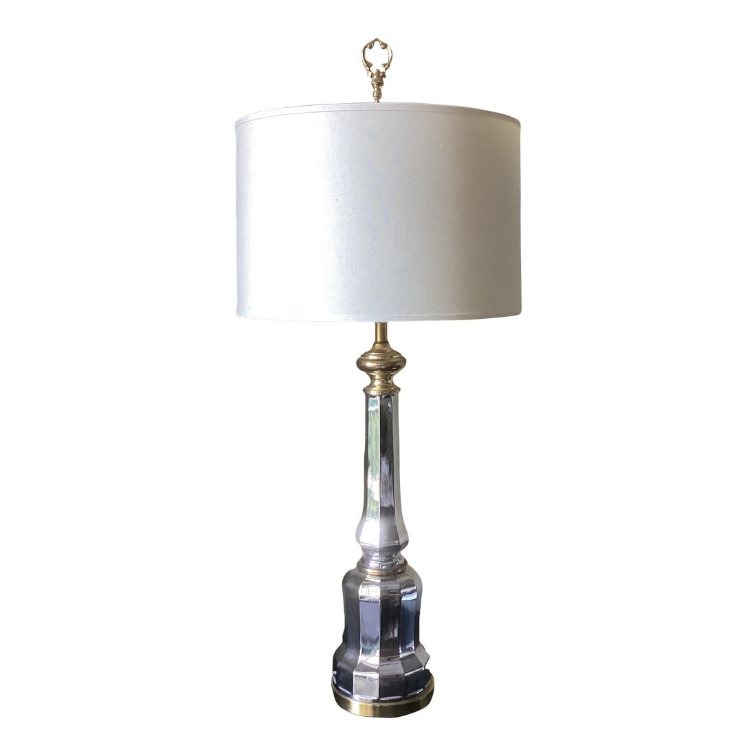 Vintage Hollywood Regency Style Silver and Gold Table Lamp With Linen Drum Shade: Add a touch of timeless elegance with this vintage table lamp, featuring a faceted silver-toned body accented by gold/brass details. The tall, sculptural base exudes classic sophistication, while the
