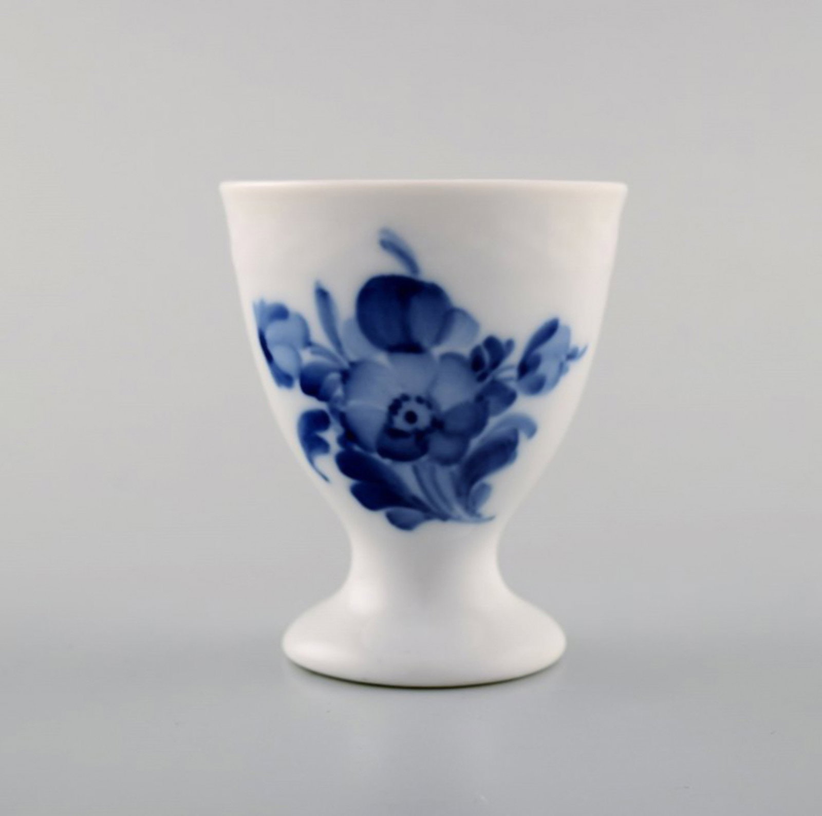 Blue flower braided egg cup from Royal Copenhagen.: Title: Blue flower braided egg cup from Royal Copenhagen. Description: Blue flower braided egg cup from Royal Copenhagen. Stamped. Number 10/8179. 1st factory quality. In perfect condition. Measures: