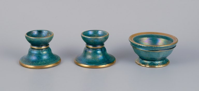 Josef Ekberg for Gustavsberg, Sweden. A pair of candle holders and a small bowl in ceramic. Glaze in: Title: Josef Ekberg for Gustavsberg, Sweden. A pair of candle holders and a small bowl in ceramic. Glaze in blue-green tones with a gold rim. Description: Josef Ekberg for Gustavsberg, Sweden. A pair