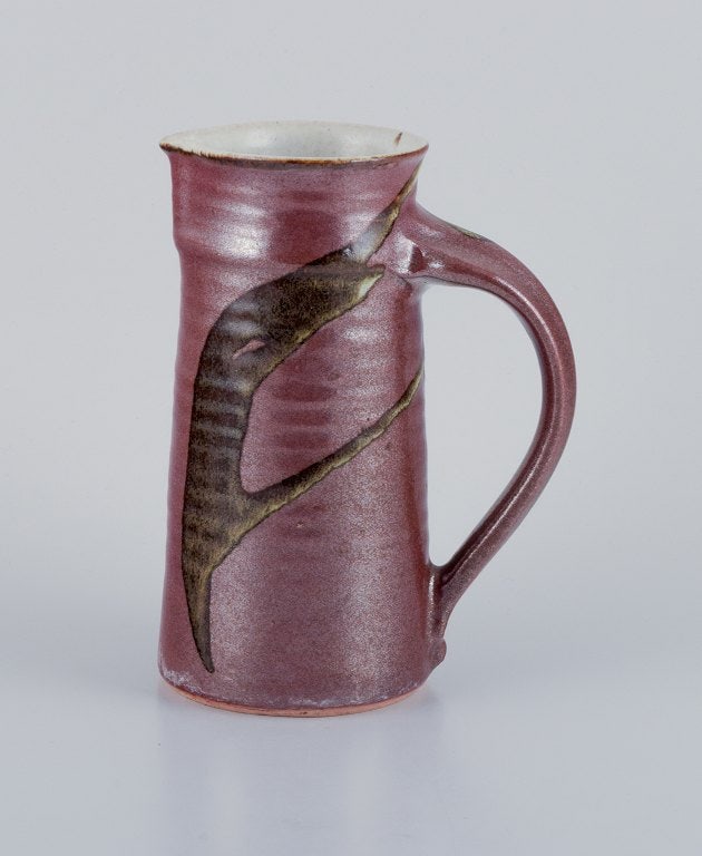 Stouby Keramik, Denmark, a handmade ceramic jug with glaze in brown and sandy tones.: Title: Stouby Keramik, Denmark, a handmade ceramic jug with glaze in brown and sandy tones. Description: Stouby Keramik, Denmark, a handmade ceramic jug with glaze in brown and sandy tones. 1970s. Sig