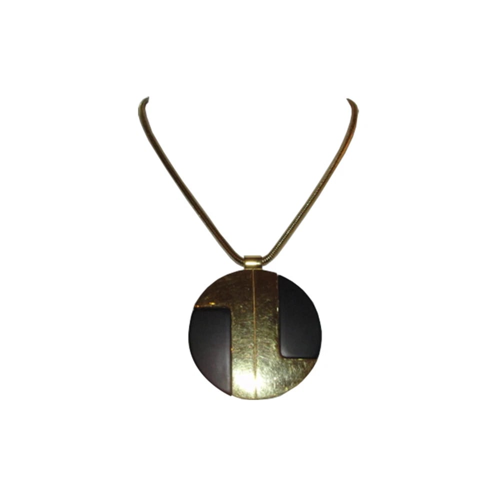 Lanvin Black and Gold Pendant Necklace: Title:Lanvin Black and Gold Pendant Necklace Description:1970's Lanvin 18 kt gold plated necklace and pendant with black plastic insert. Necklace is 19" long 4mm's diameter. Pendant is 3" diameter. Ma