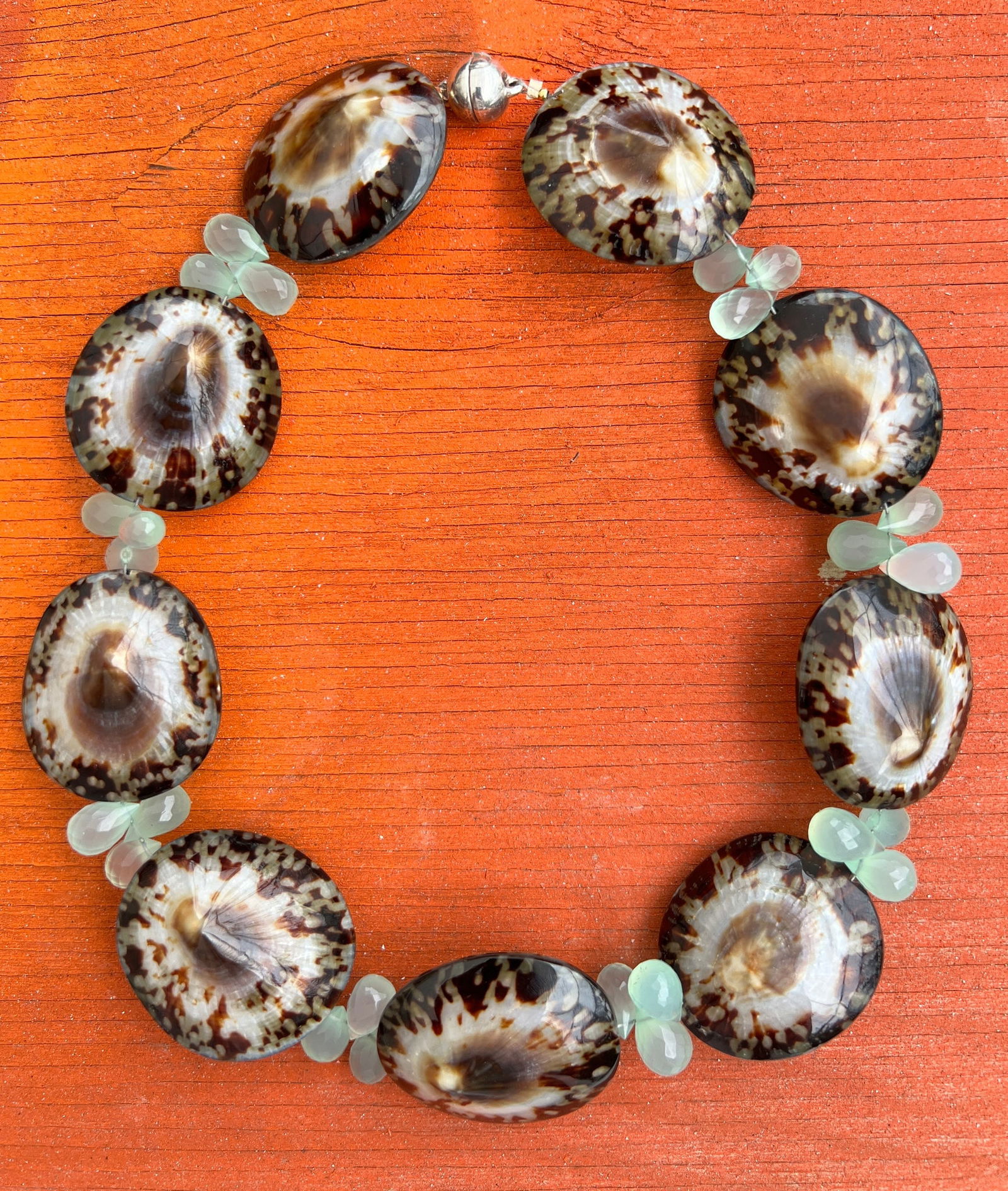 Limpet Shell and Green Amethyst Necklace: Title:Limpet Shell and Green Amethyst Necklace Description:Polished Limpet Shell pairs neatly in a row, interrupted only by trios of raw Green Amethyst. - Signed CSS - Magnetic closure - 16.5" long Re