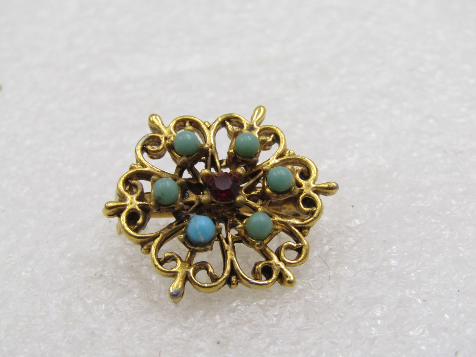 Vintage Victorian Themed Brooch, Rhinestone & Faux Turuqoise, 7/8": Vintage Victorian Themed Brooch, Rhinestone & Faux Turuqoise, 7/8". A 1960's brooch to look like a Victorian piece. It has six faux turquoise snakeyes stones and a center deep red 2.5mm rhinestones. S