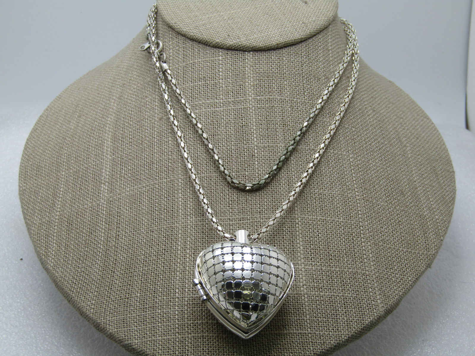 Vintage Puffy Heart Locket Necklace, 36", Mesh, 1990's: Vintage Puffy Heart Locket Necklace, 36", Mesh, 1990's. The heart is a Puffy tiled hinged heart that is appx. 1.5" tall and wide and nearly 1" thick. Silver tone metal. The chain is silver tone with a