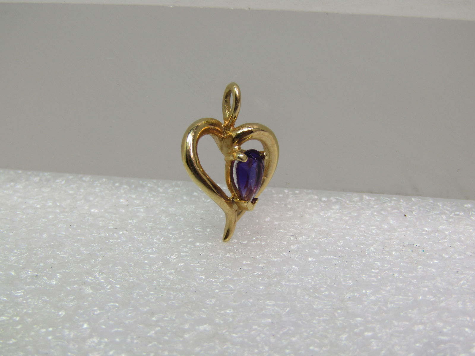 Vintage 14kt Amethyst Open Heart Pendant, 1970's-1980's: Vintage 14kt Amethyst Open Heart Pendant, 1970's-1980's. This is an open heart curved with higher and lower design in 14kt yellow gold - tests as 14kt with an appx. weight of 1.31 grms. It hs a three-