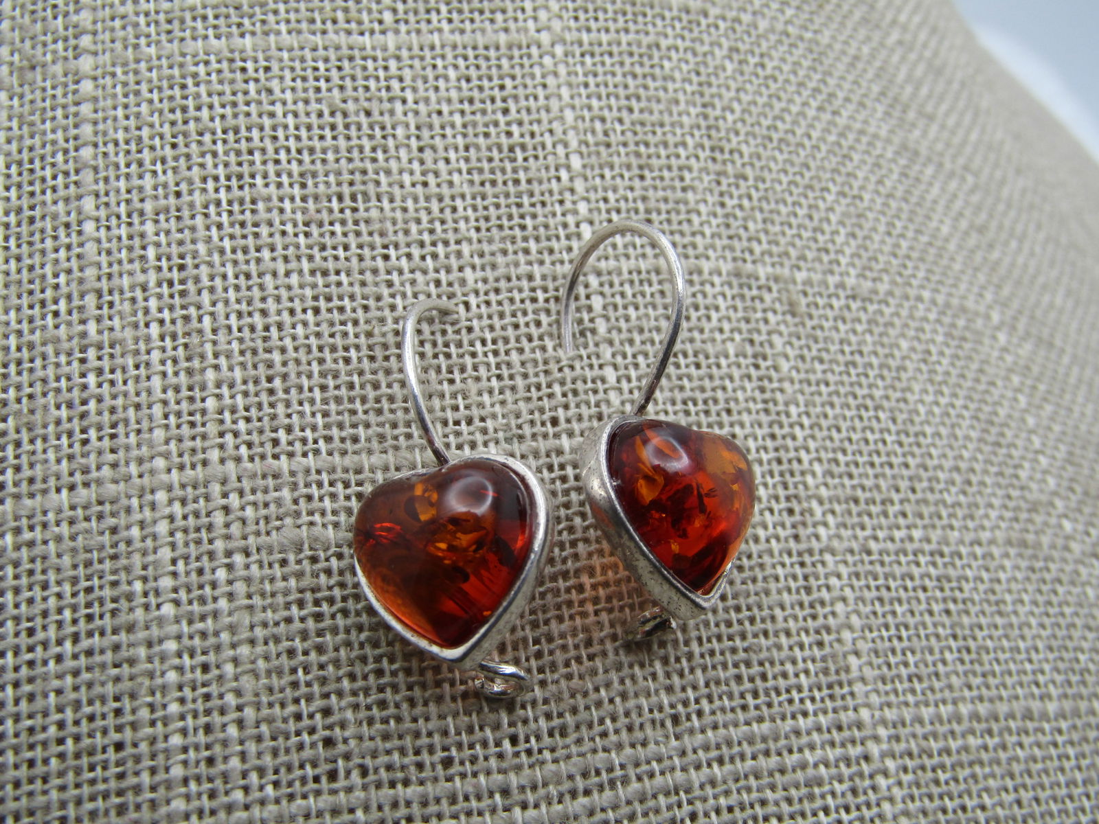 Vintage Sterling Baltic Amber Heart Earrings, Pierced, 1980's-1990's: Vintage Sterling Baltic Amber Heart Earrings, Pierced, 1980's-1990's. These have looking hook posts and are appx. 1.25" long from the curve in the hook. The hearts are bezel-set and test as amber with