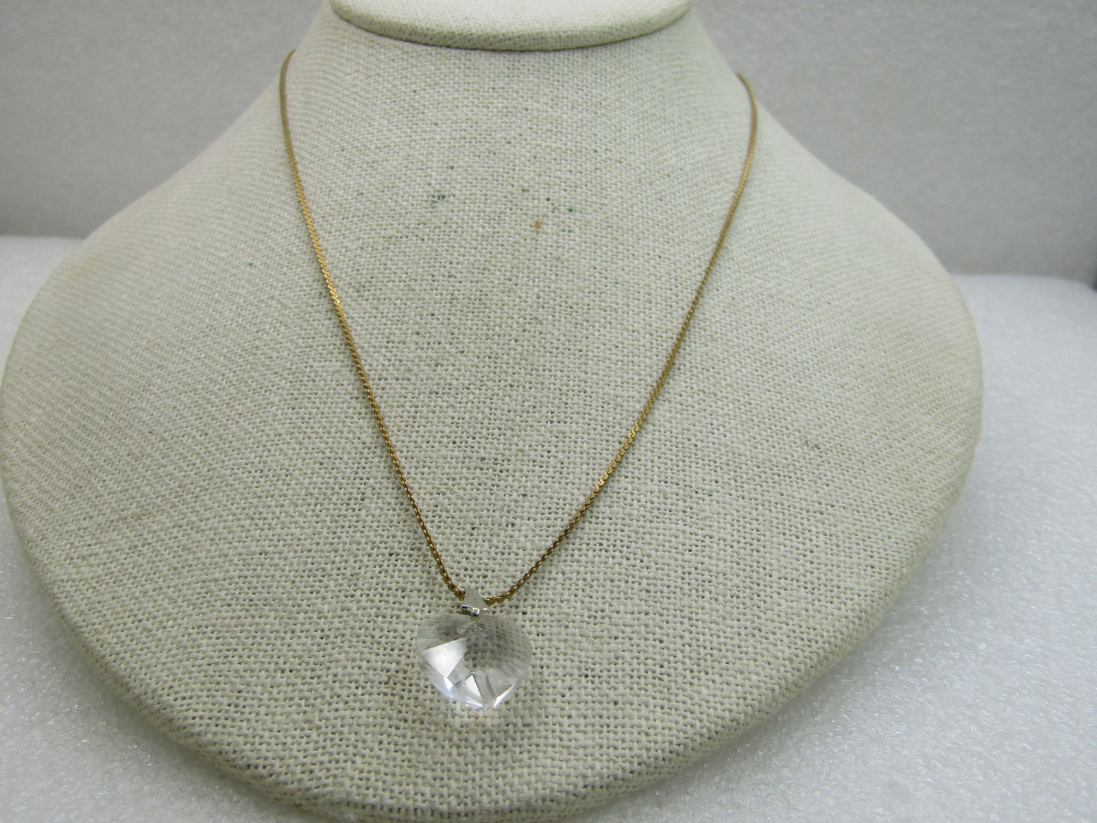 Vintage Crystal Heart Necklace, 18" Herringbone Chain: Vintage Crystal Heart Necklace, 18" Herringbone Chain. The bail on the heart is silver tone and the chain is a 1mm gold tone herringbone chain signed Korea with spring clasp. The heart is a cut crysta