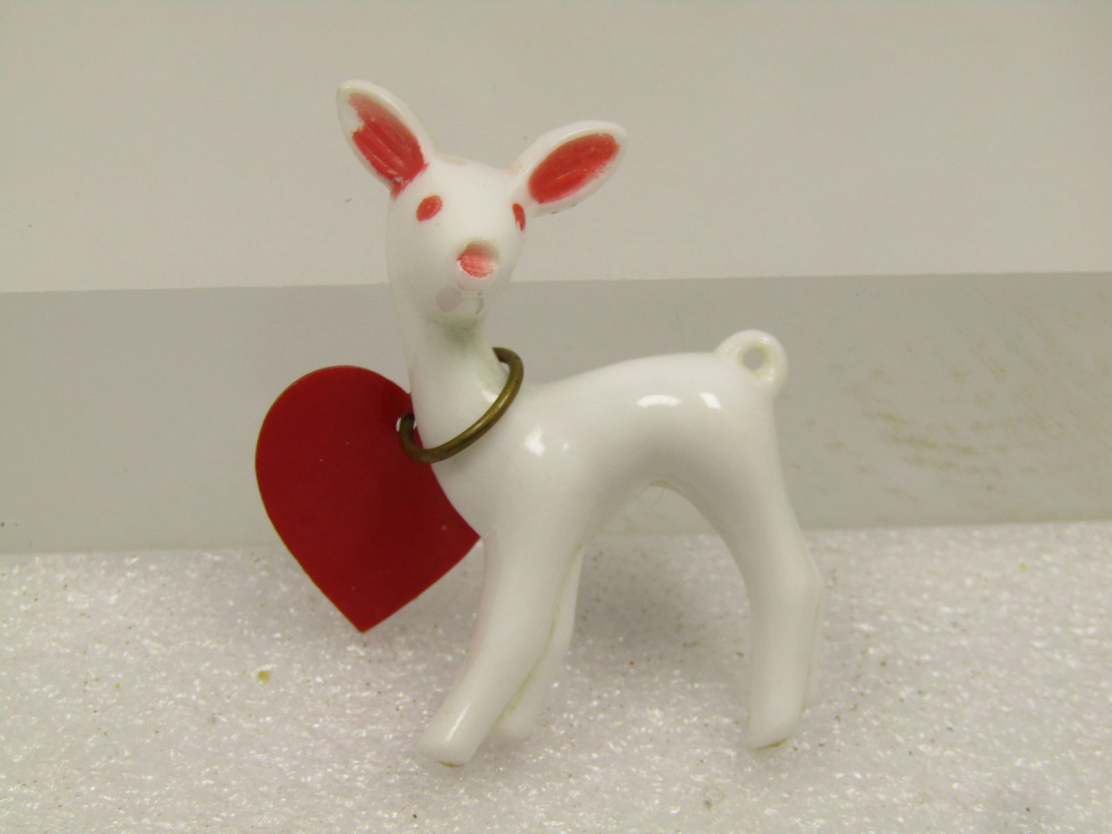 Vintage Valentine Deer Brooch, 1950's: Vintage Valentine Deer Brooch, 1950's. This is a white thermoset plastic deer with pin eyes, inside ears and nose. it has a plastic large heart at it's neck. C-clasp pin set into the back of the deer