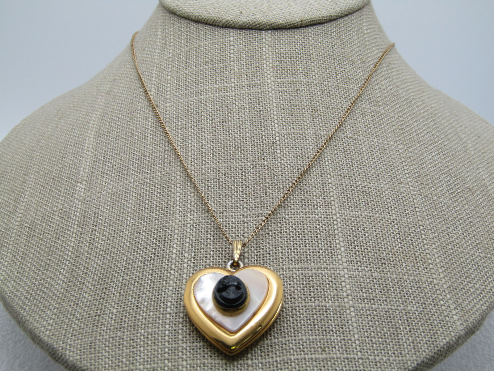 Vintage MOP Cameo Heart Locket Necklace, 16", 12kt. G.F., 1950's-1960's: Vintage MOP Cameo Heart Locket Necklace, 16", 1950's-1960's. The heart locket has a swing bail and is appx. 1-3/8" tall and 1" wide. I has an inlaid mother-of-pearl base with an oval black molded beze