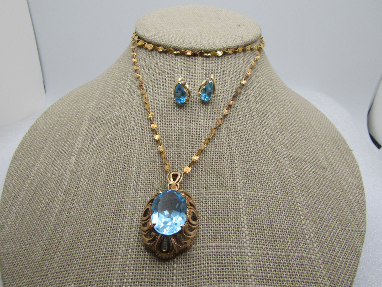 Blue Topaz 10kt Pendant & 14kt Earrings with Diamonds, .925 Vermeil 24 Chain, Danecraft: Blue Topaz 10kt Pendant & 14kt Earrings with Diamonds, .925 Vermeil 24 Chain, Danecraft. This is a large 10kt filigree heart base with a large 16mmy by 11mm blue topaz stone that is appx. 7 CTW stone.