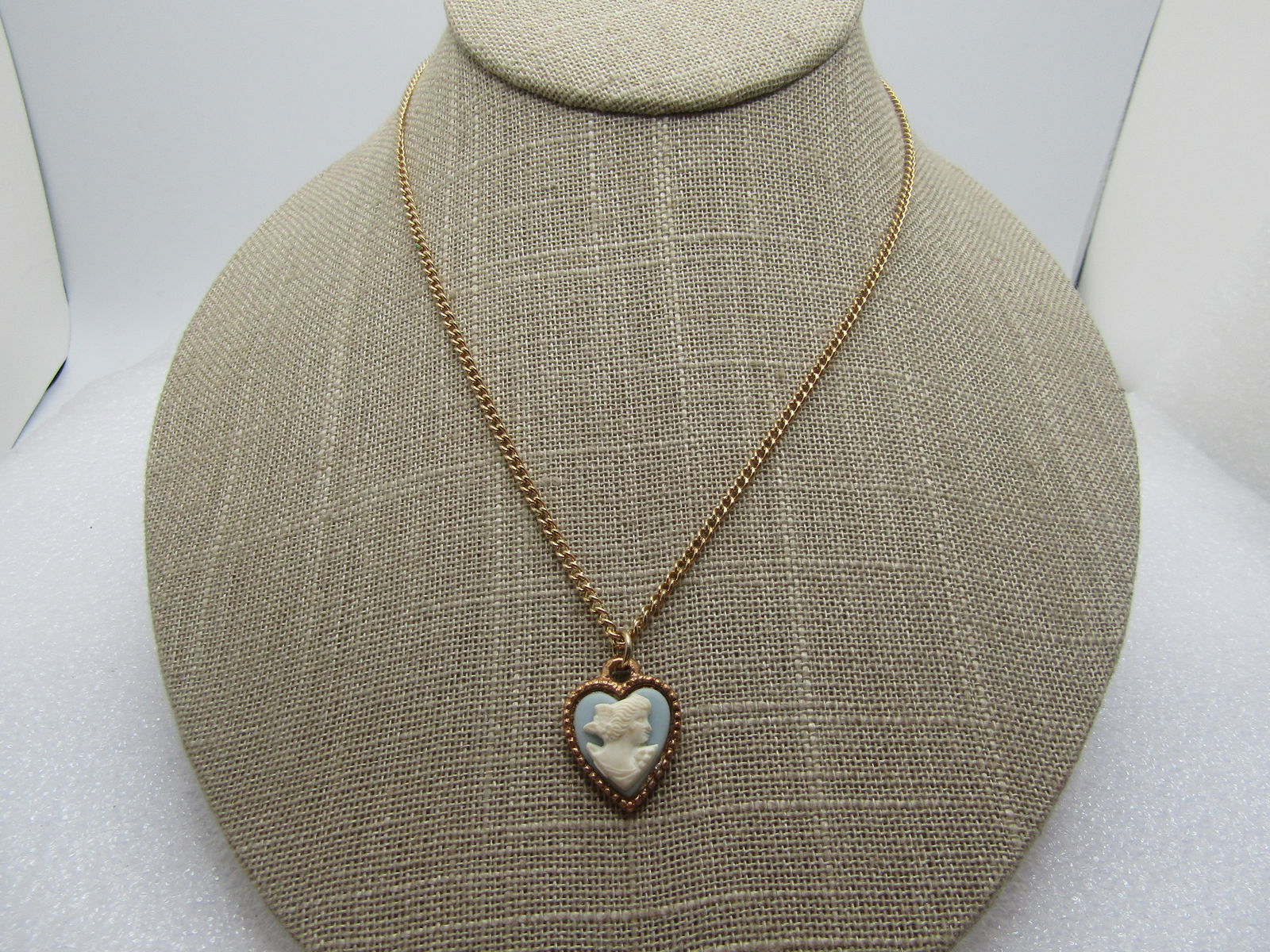 Vintage Blue Heart Cameo Necklace, 16", 1960's: Vintage Blue Heart Cameo Necklace, 16", 1960's. Gold tone with a 1mm curb link chain and spring clasp. Molded plastic faux Wedgwood cameo. Heart shaped set in a heart. The pendant is appx. 3/4" with r
