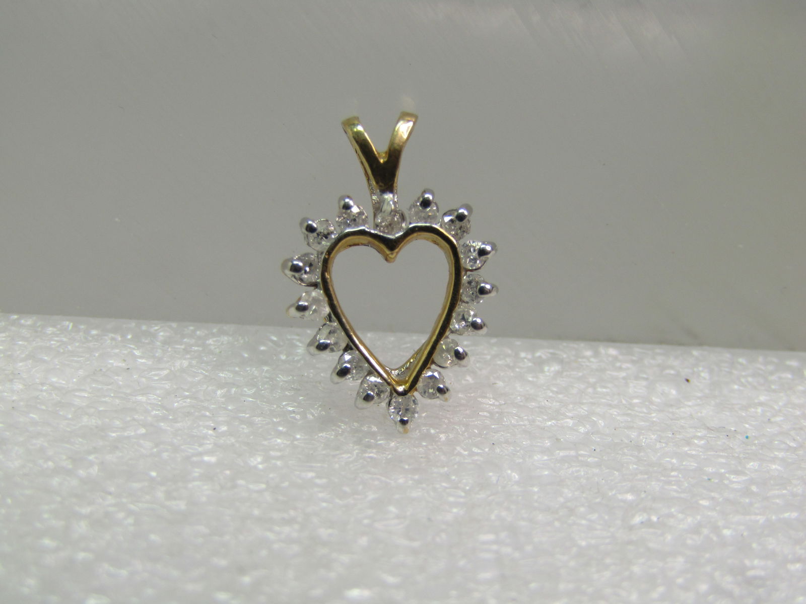 Vintage 14kt Diamond Heart Pendant, Two-Tone, 1960's-1980's.: Vintage 14kt Diamond Heart Pendant, Two-Tone, 1960's-1980's. This has sixteen round appx. 1mm diamonds setin white gold with pront on outer edge and channel on inner frame. Yellow gold base and bail.