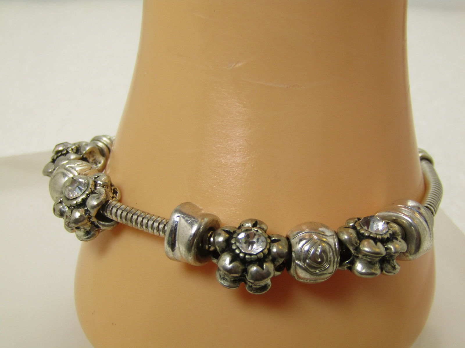 Vintage Brighton Floral & Rhinestone Bracelet, Slide Charms, 7.5", 1990's: Vintage Brighton Floral & Rhinestone Bracelet, Slide Charms, 7.5". 1990's. This has the Brighton heart chunky lobster clasp with an appx. 3.3mm round snake chain bracelet with four blossom slide beads