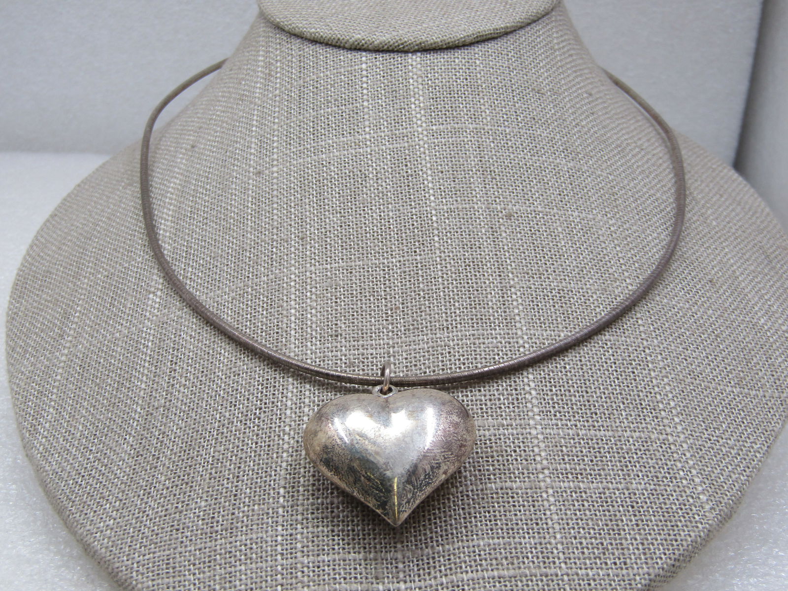 Vintage Sterling Puffy Heart Omega Necklace, 18": Vintage Sterling Puffy Heart Omega Necklace, 18", appx. 15.67 grams. The necklace has the Omega look and is appx. 2mm round. Marked .925 and Italy and has a maker's mark that is a diamond shape with t