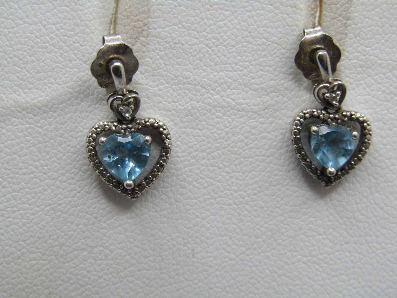 Vintage Sterling Topaz & Diamond Heart Earrings, Pierced: Vintage Sterling Topaz & Diamond Heart Earrings, Pierc. The earings has a vertical bar like stud with a lower open heart around them with a diamond chip in the center and below that is an illusion hal