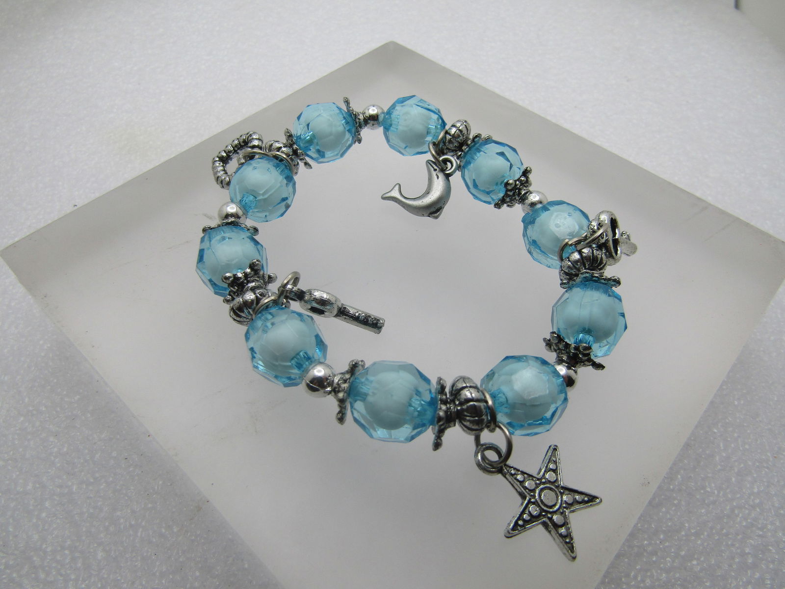 Acrylic & Silver Tone Stretch Bracelet, Blue, Stars, Key, Hearts & More, 1990's: Acrylic & Silver Tone Stretch Bracelet, Blue, Stars, Key, Hearts & More, 1990's. Stetch bracelet up to 7.5" - with blue clear faceted acrylic beds with a white center - they are papx. 11mm wide with s