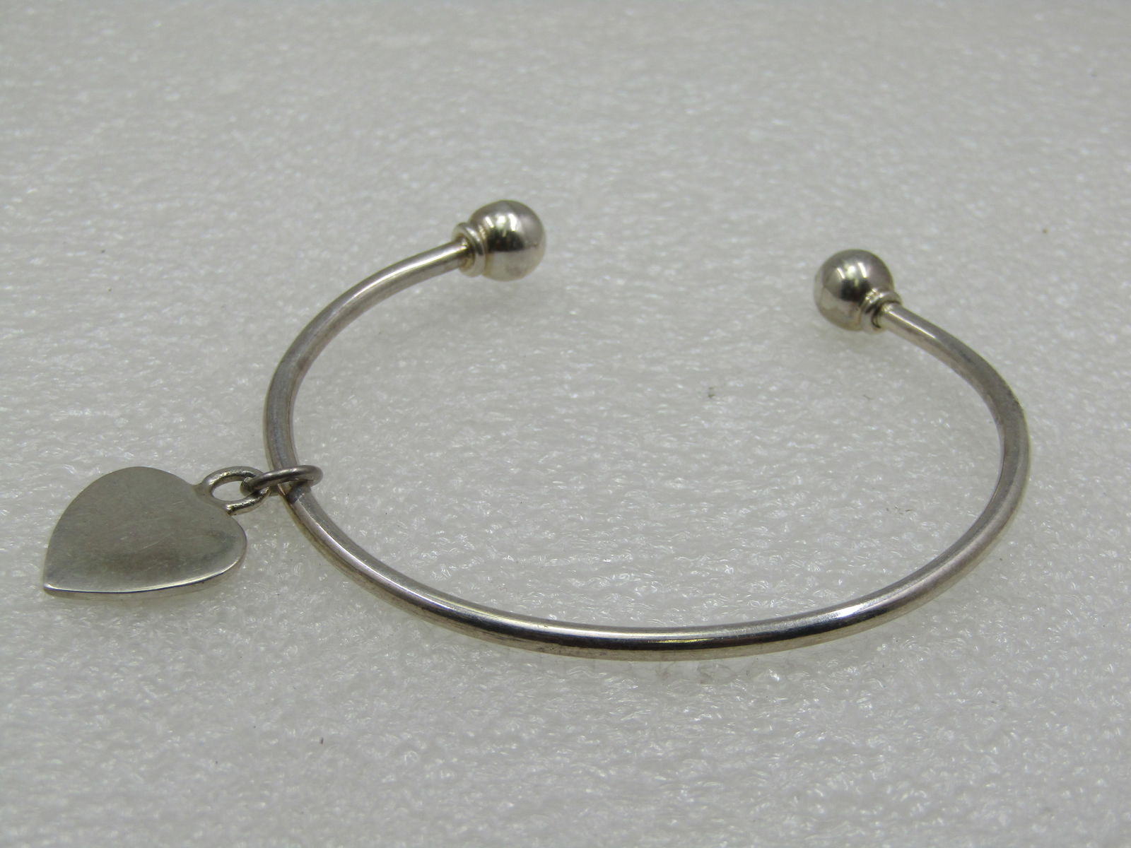 Sterling Silver Sliding Heart Cuff/Bangle Bracelet: Sterling Silver Sliding Heart Cuff/Bangle Bracelet 7.25" is the measurement around the wrist including the open area. Easy to slide on and off a wrist and looks very nice on - the heart has nice movem