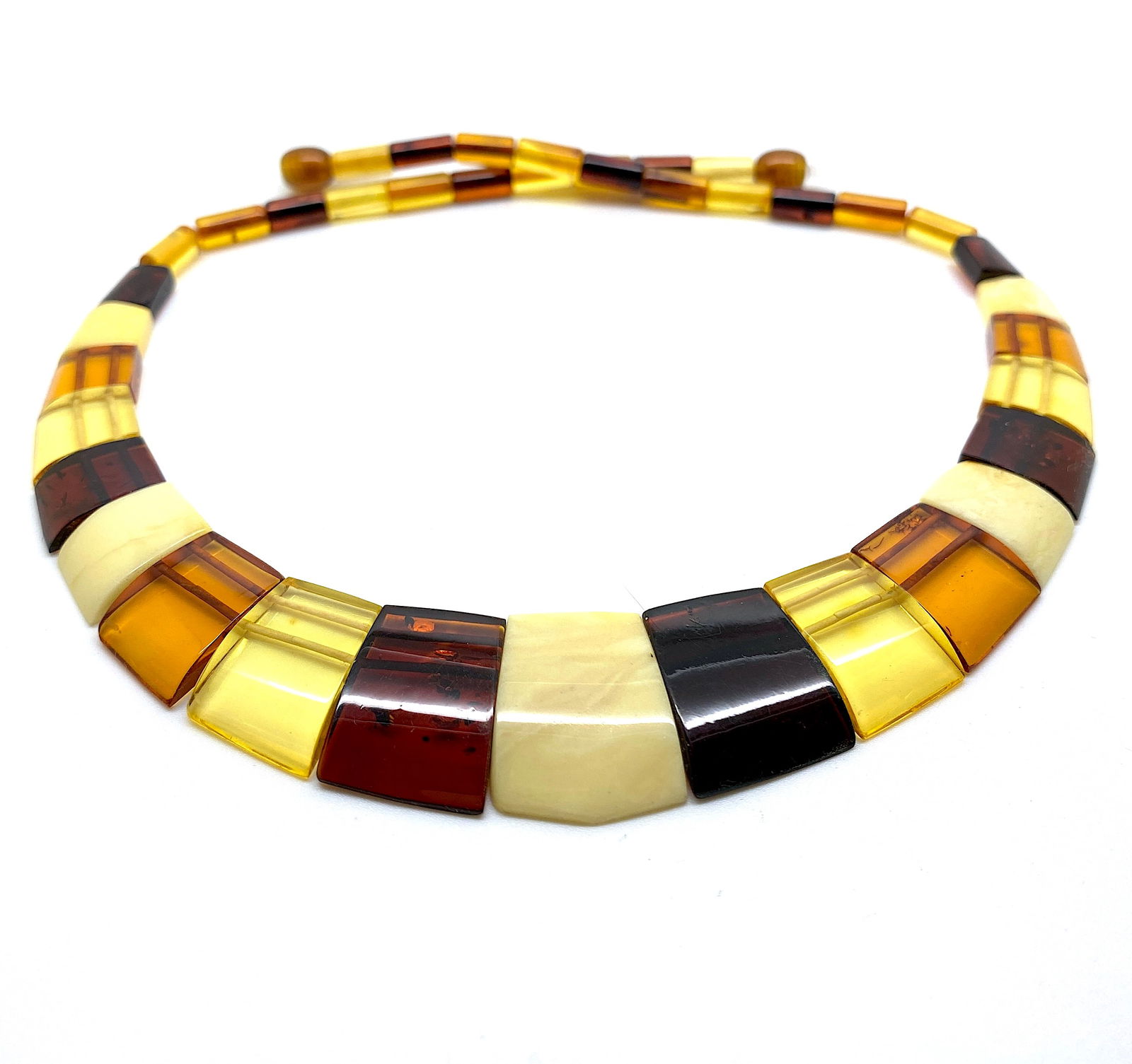 Staggering Amber Cleopatra necklace: Title:Staggering Amber Cleopatra necklace Metal:None Gemstone:Amber Weight:17.63 g Size:Size: 460.0 x 22.0 x 5.0 mm Size: 18.11 x 0.866 x 0.197 inches Made of:(Reconstituted Amber or Whole Stone):Whol