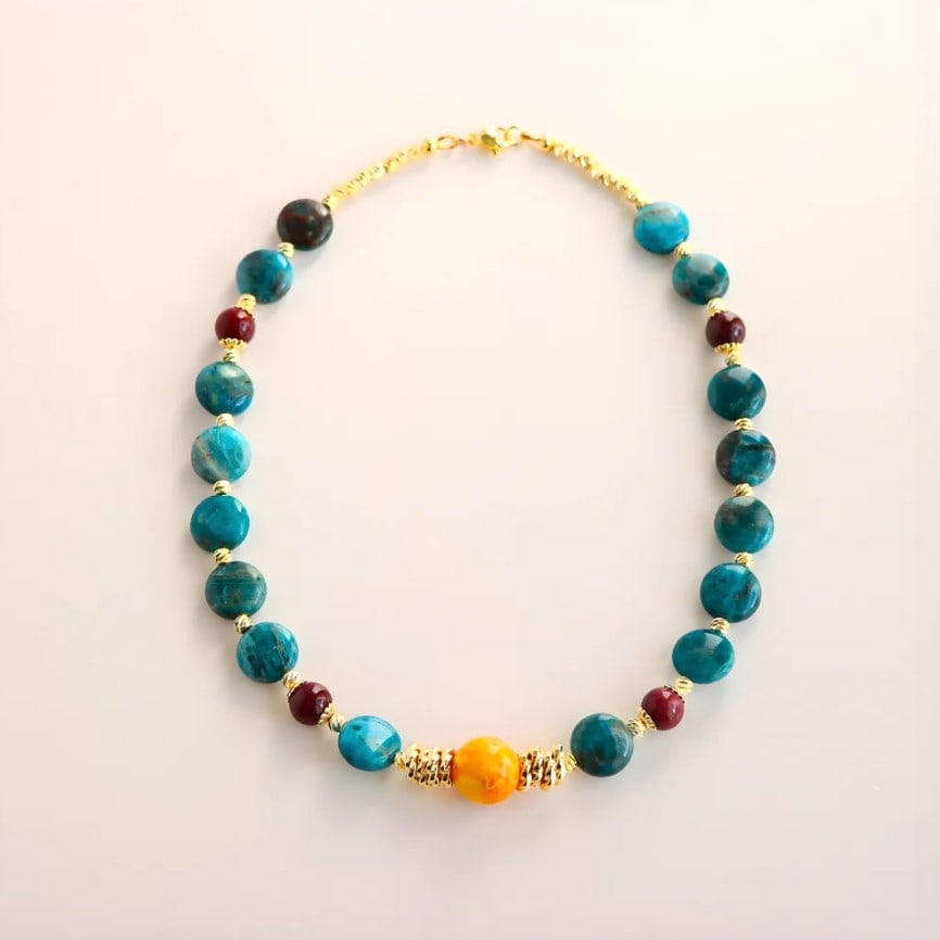 Baltic Amber and Azurite Beaded Necklace: Title:Baltic Amber and Azurite Beaded Necklace Description:This Baltic butterscotch amber beaded necklace features a vibrant mix of natural stones and golden detail. Handcrafted by Alexis Dallmann, it