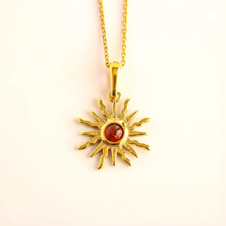 Baltic Amber Sun Necklace in 14k Gold Plated Sterling Silver: Title:Baltic Amber Sun Necklace in 14k Gold Plated Sterling Silver Description:This amber sun necklace features a petite Baltic amber cabochon set at the center of a radiant sun motif. Crafted in 14k