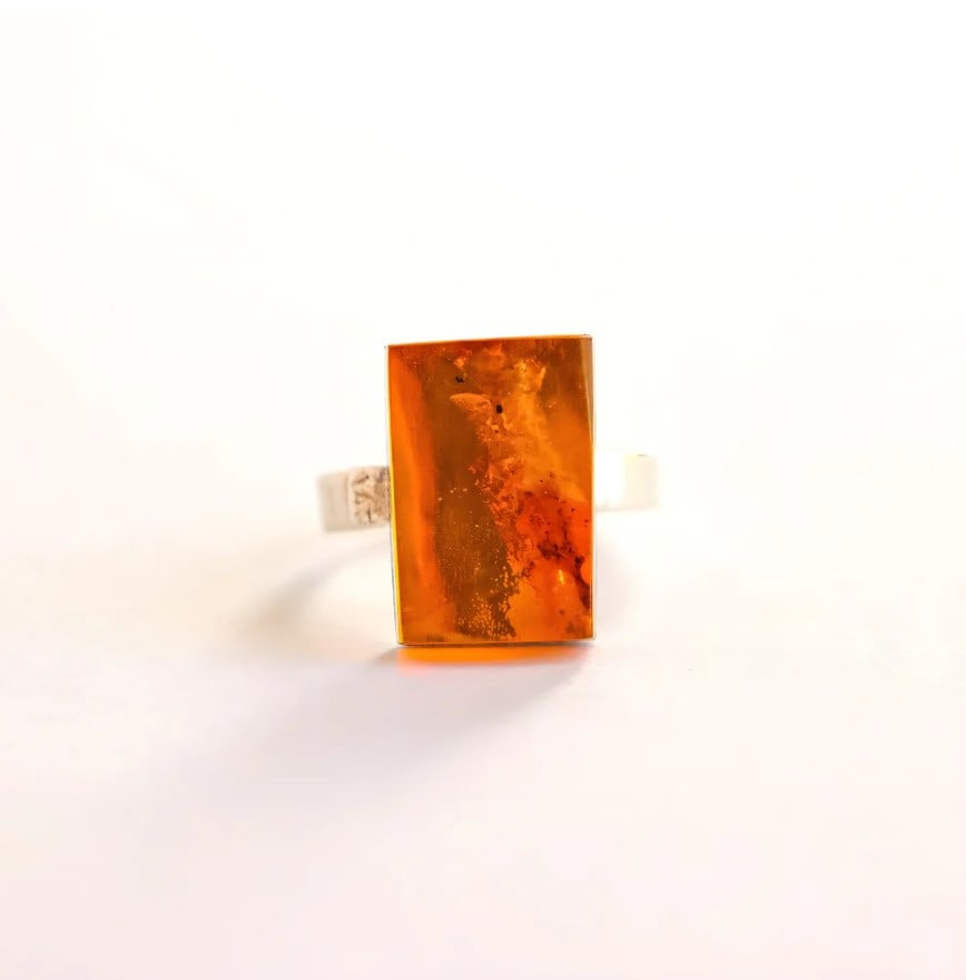 Mariusz Gliwiński Baltic Amber Ring in Sterling Silver: Title:Mariusz Gliwiński Baltic Amber Ring in Sterling Silver Description:This amber ring features genuine Baltic cognac amber set in a clean, contemporary sterling silver design. Created by renow