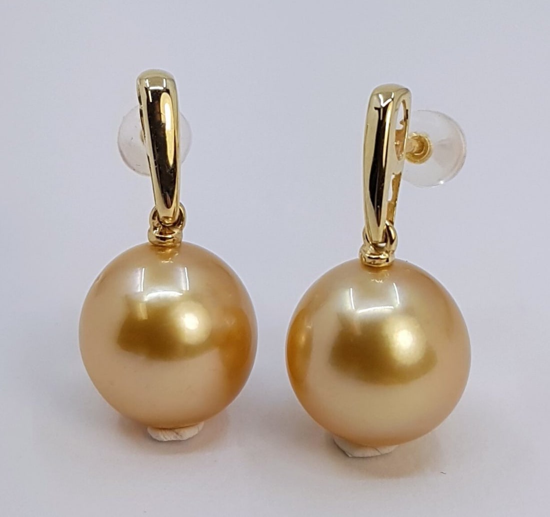 Earrings - 14 kt. Yellow gold - 11x12mm South Sea Pearls: Title: Earrings - 14 kt. Yellow gold - 11x12mm South Sea Pearls Description: Produced by the gold-lipped Pinctada Maxima Oyster in the warm waters of Indonesia, these pearls have a natural magnificent